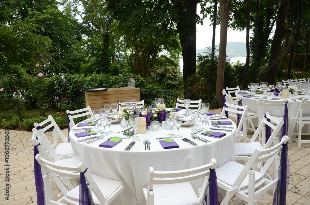 Elegant Outdoor Wedding Ceremony with Purple Hydrangeas and White Chairs