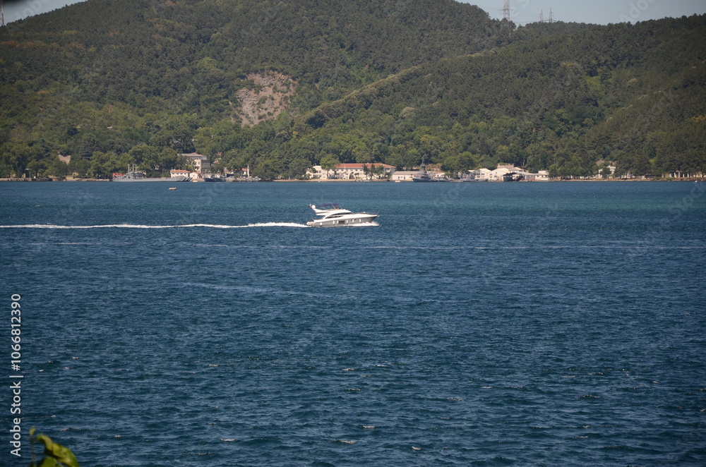 Speedboat Cruising Through a Serene Strait: A Breathtaking View of Nature and Water Sports. Speedboat Cruising Through a Serene Strait: A Breathtaking View of Nature and Water Sports.
