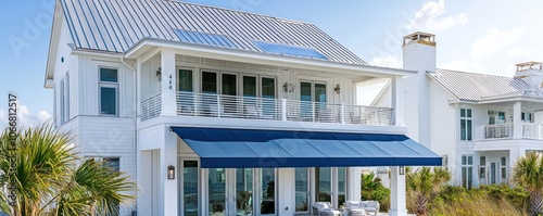 Obraz na płótnie Beach home with a metallic gray roof and vibrant blue awning. w salonie