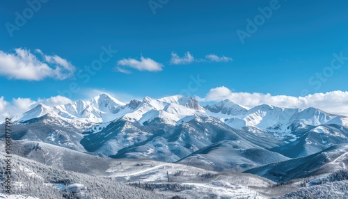 Snow-capped Mountains with a Blue Sky and White Clouds