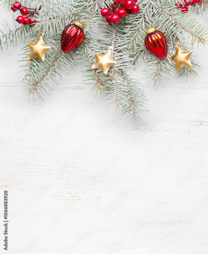 Fir branch with Christmas ornaments on old wooden shabby background with empty space for text. Christmas and New Year background.