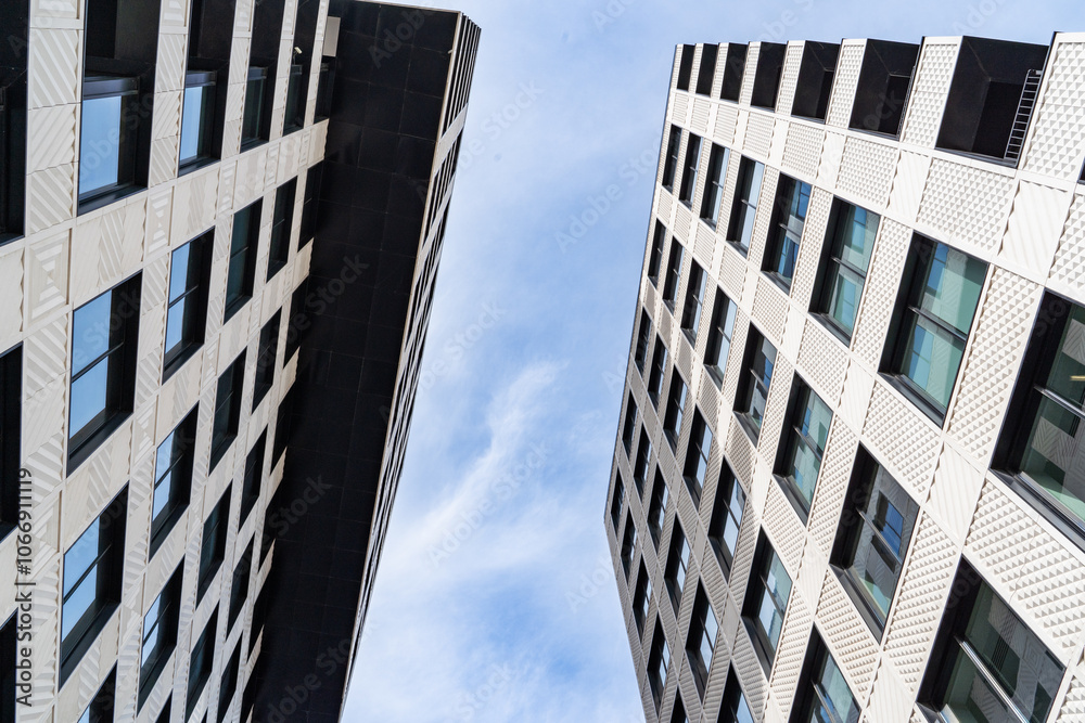 Modern Urban Architecture Showcased Among Tall Buildings Beneath a Blue Sky