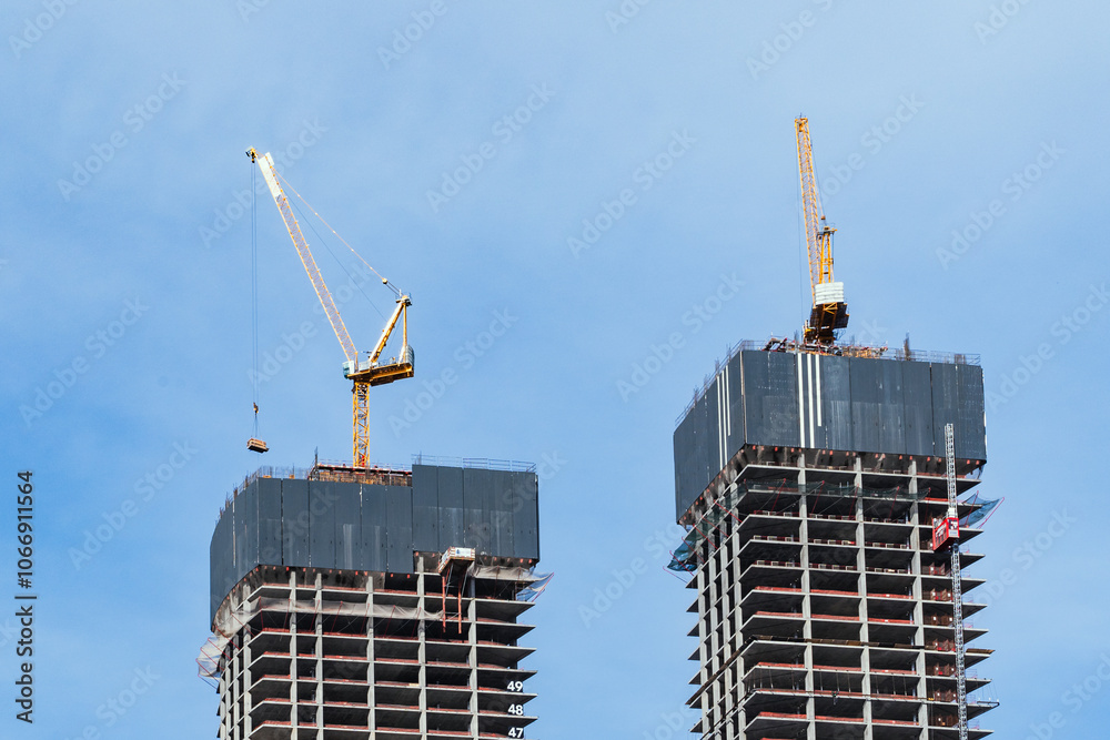 The construction of modern skyscrapers involves the use of cranes and various advanced technologies