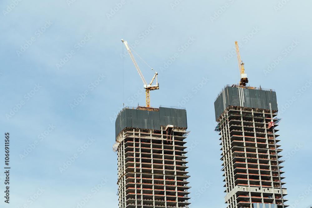 The construction of modern skyscrapers involves the use of cranes and various advanced technologies
