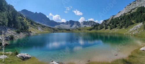 Fototapeta Naklejka Na Ścianę i Meble -  A large body of water with a mountain in the background