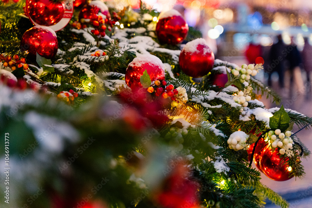 Festively decorated Christmas setting featuring bright red ornaments and a snowy background