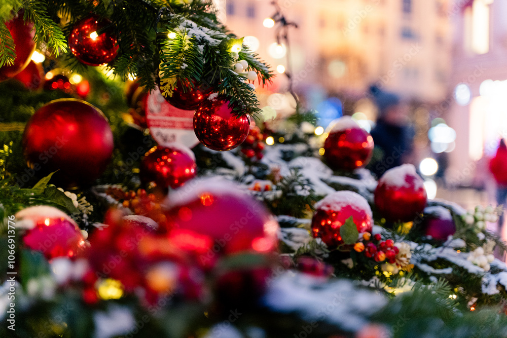Festively decorated Christmas setting featuring bright red ornaments and a snowy background
