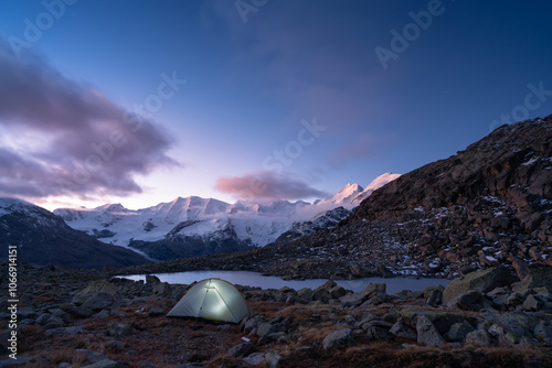 A tent at a lake in the Bernina mountain group, Switserland, during dawn. photo