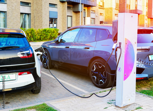 Charging Electric Car. Charge an Electric Car. Powered car charging station. Energy Powered Battery Electric Vehicle charging station. EV charging station for electric cars. EV Auto on charge photo