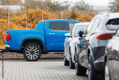 Wallpaper Mural Side view of blue new ev pickup truck parked at outdoor parking lot automobile dealer or parking place against autumn foliage. Modern SUV electric vehicle outside Torontodigital.ca