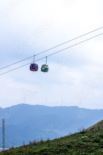 two ski lifts are suspended in the air one of which is a cable car