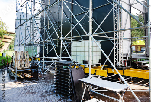 Backstage equipment and scaffolding for an outdoor event setup. photo