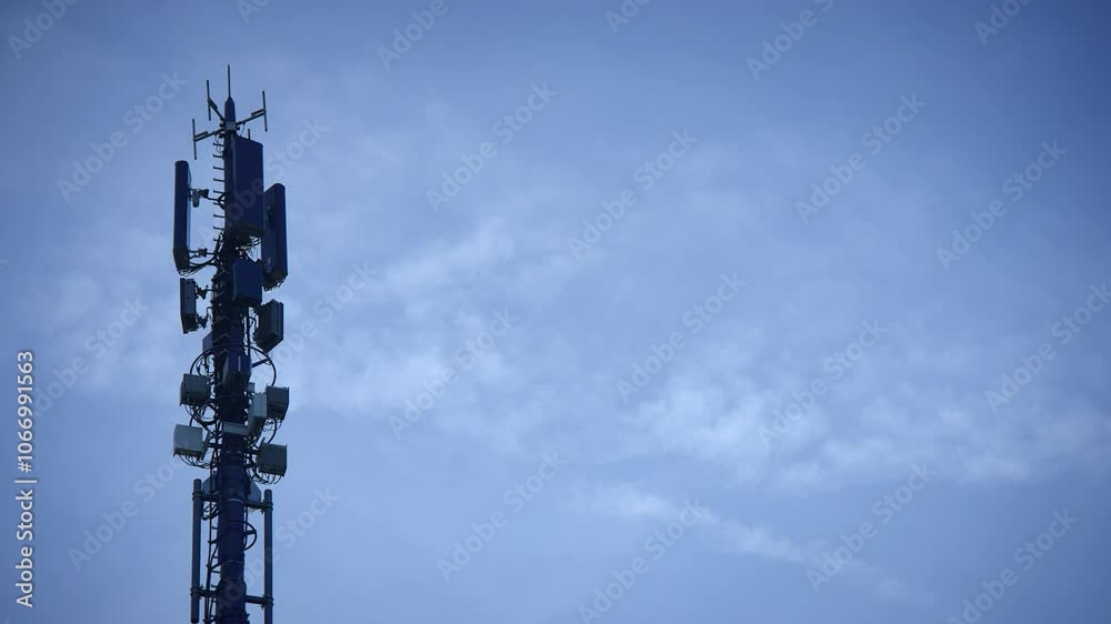 A Tall Telecommunication Tower Standing Majestically Against a Clear Blue Sky Above A Tall Telecommunication Tower Standing Majestically Against a Clear Blue Sky Above