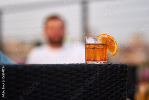 yellow alcohol cocktail with a slice of lemon on a bokeh background	