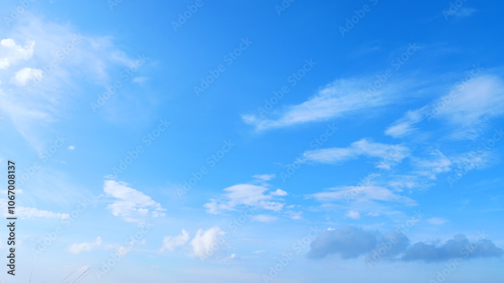Fototapeta premium Bright blue sky with scattered beautiful clouds