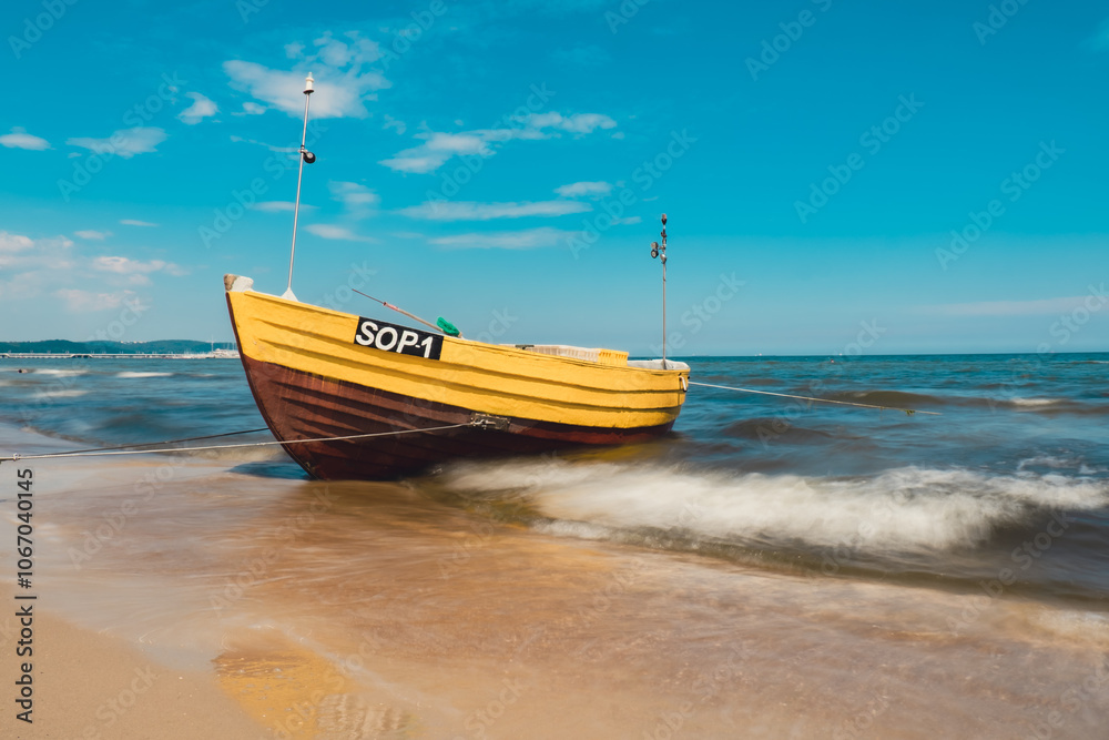 Fishing boat on the beach in Sopot, Poland. Magnificent long exposure calm Baltic Sea. Wallpaper defocused waves. Fishermans sea bay Vacation and holidays. travel attraction tourist destination Fishing boat on the beach in Sopot, Poland. Magnificent long exposure calm Baltic Sea. Wallpaper defocused waves. Fishermans sea bay Vacation and holidays. travel attraction tourist destination
