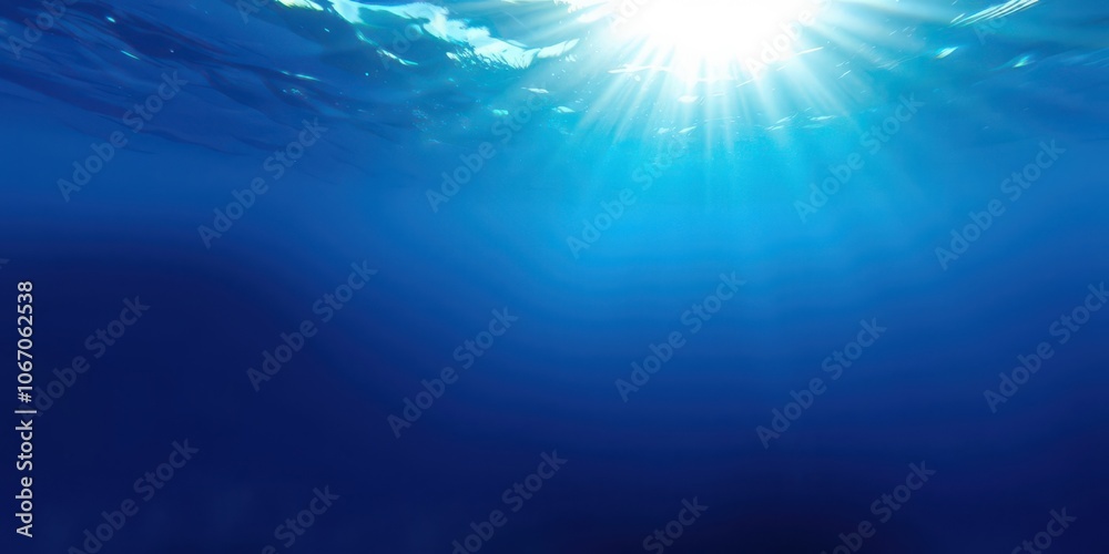 Dark blue ocean surface viewed from underwater with sunlight filtering through, marine, surface