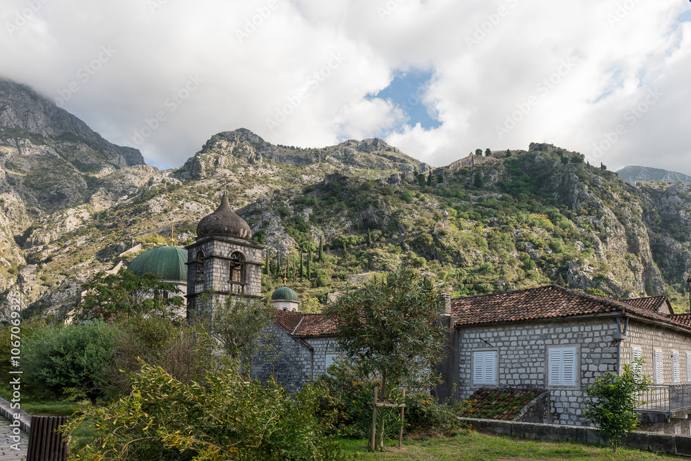 Church of St. Nikola in Kotor. Fortress with mountains in the background Church of St. Nikola in Kotor. Fortress with mountains in the background
