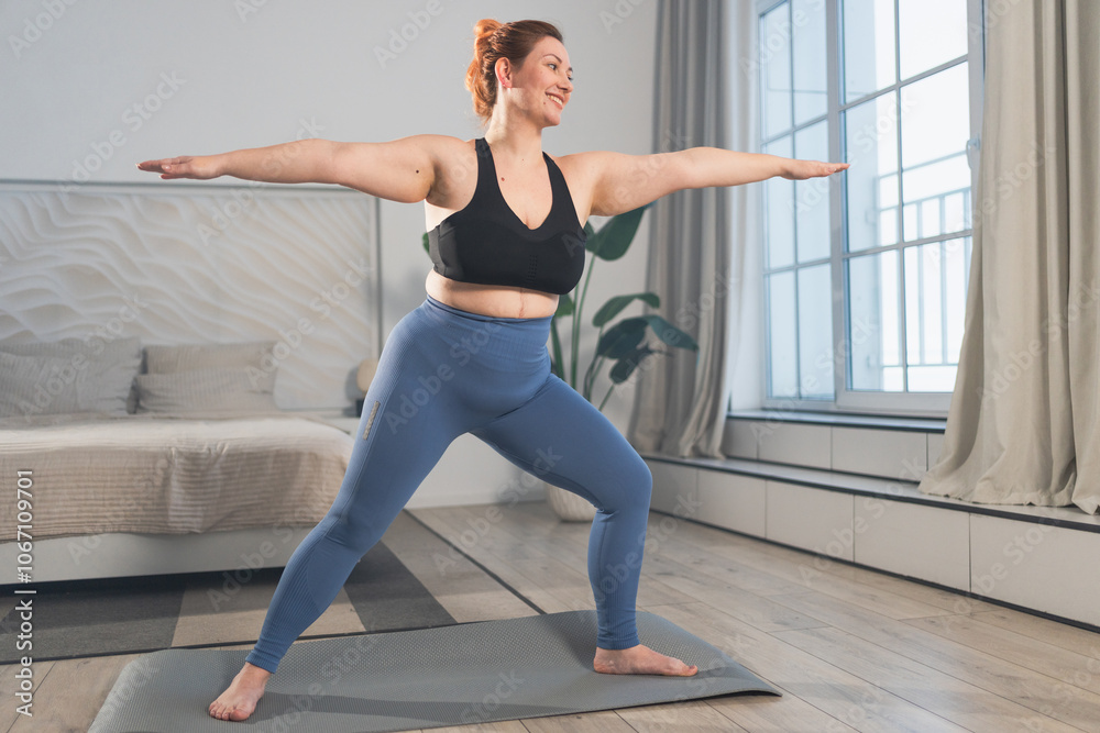 Yoga fitness workout training. Woman practicing yoga at home. Plus size female doing sports exercise on yoga mat indoor. Girl in sportswear have training workout for weight loss. Sport and fitness