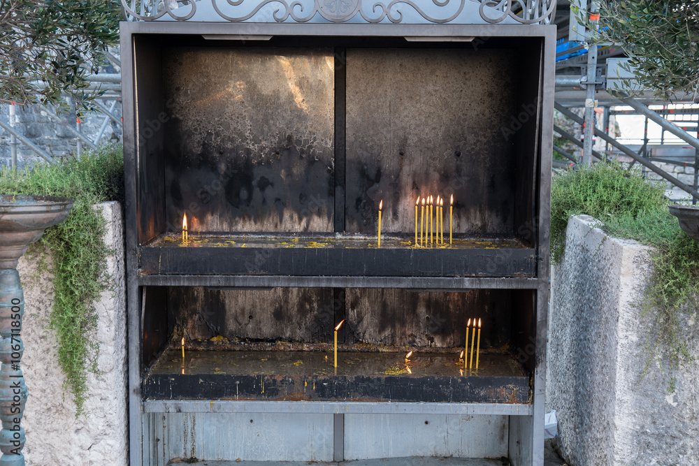 Traditionally burned candles for the soul of the dead outside of a Christian Orthodox church Traditionally burned candles for the soul of the dead outside of a Christian Orthodox church
