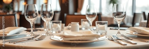 elegant table setting with fine china, crystal glassware, and polished silverware in upscale restaurant, luxury