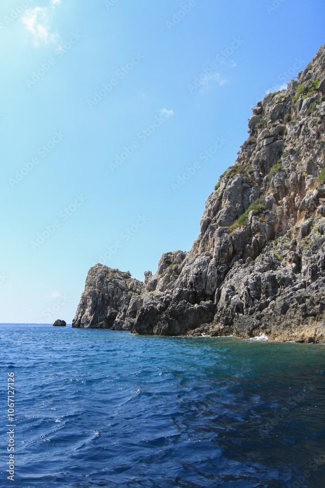 Scenic Greek Islands Landscape: Rock Formations, Cliffs, and Coastal Houses Viewed from the Sea Scenic Greek Islands Landscape: Rock Formations, Cliffs, and Coastal Houses Viewed from the Sea