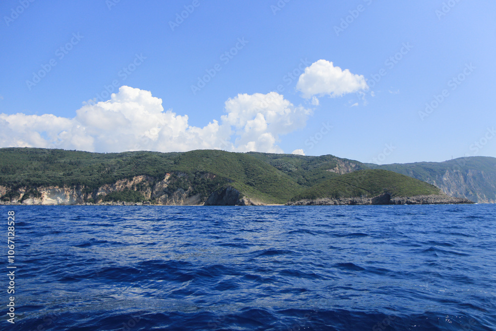 Scenic Greek Islands Landscape: Rock Formations, Cliffs, and Coastal Houses Viewed from the Sea Scenic Greek Islands Landscape: Rock Formations, Cliffs, and Coastal Houses Viewed from the Sea