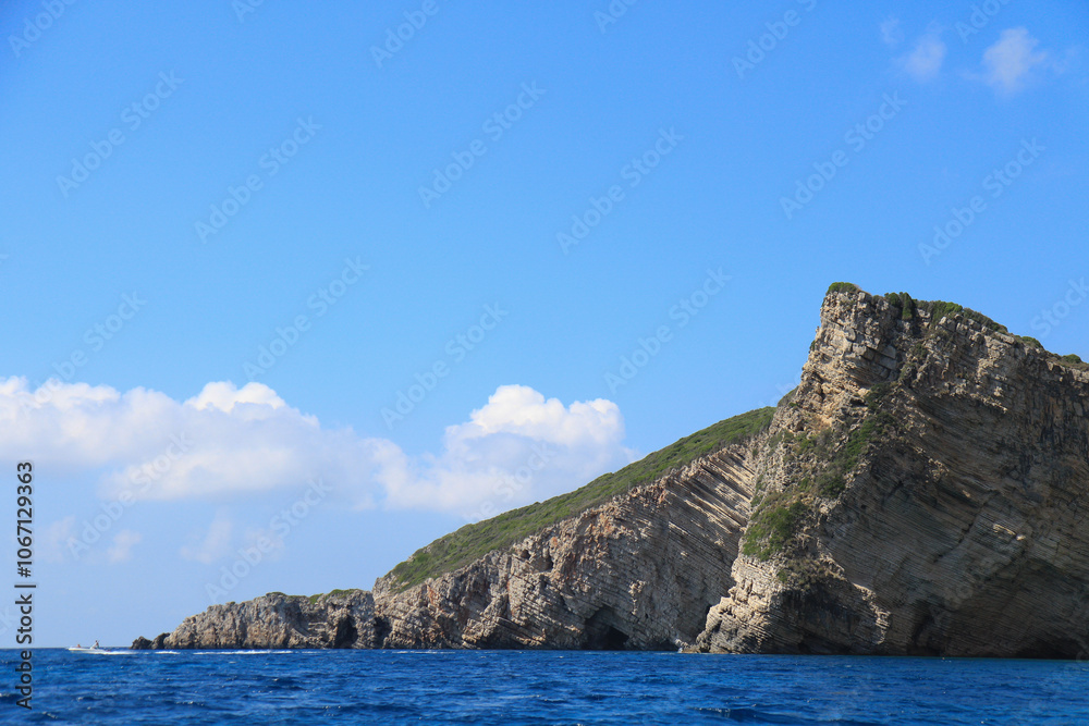 Scenic Greek Islands Landscape: Rock Formations, Cliffs, and Coastal Houses Viewed from the Sea Scenic Greek Islands Landscape: Rock Formations, Cliffs, and Coastal Houses Viewed from the Sea