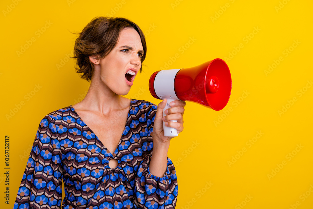 Photo of young angry activist demonstration leader holding bullhorn screams her terms to government isolated on yellow color background Photo of young angry activist demonstration leader holding bullhorn screams her terms to government isolated on yellow color background