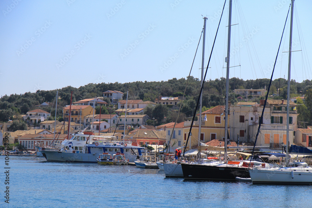 Marina on a Greek Island: Old Town Buildings by the Shore with Beautiful Nature Surrounding the Area Marina on a Greek Island: Old Town Buildings by the Shore with Beautiful Nature Surrounding the Area