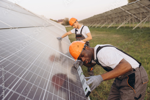 Engineers Installing Solar Panels in a Field Setting photo