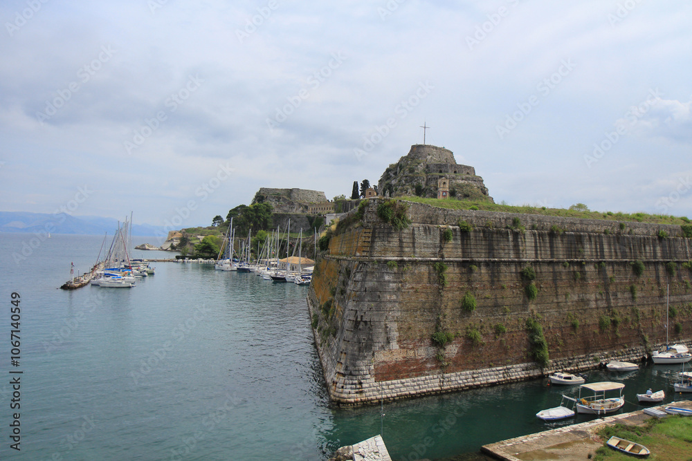 Fortress on the Sea Near a Greek Island: Historic Structure with a Cross on Top Overlooking the Ocean Fortress on the Sea Near a Greek Island: Historic Structure with a Cross on Top Overlooking the Ocean