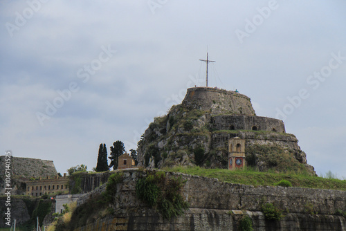 Fortress on the Sea Near a Greek Island: Historic Structure with a Cross on Top Overlooking the Ocean