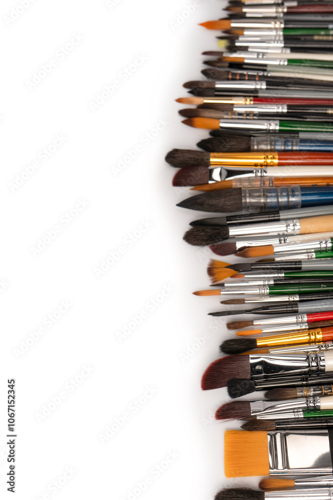 Mix of paint brushes in a row isolated on a white background. Mix of paint brushes in a row isolated on a white background.