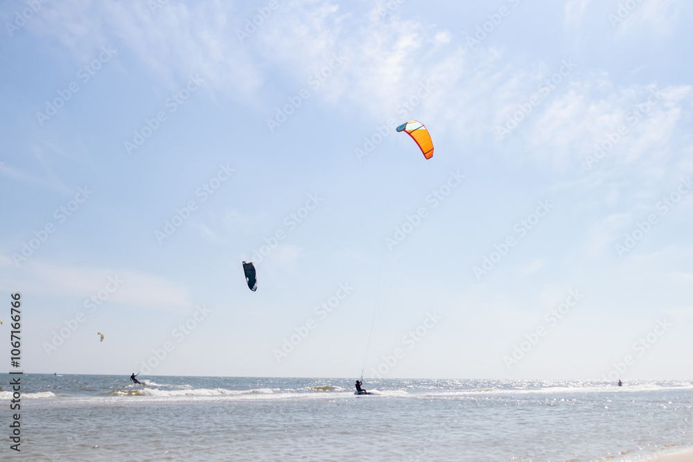 Dynamic kite surfing scene with colorful kites soaring over serene waves and a bright sky, showcasing adventure and sportsmanship. Dynamic kite surfing scene with colorful kites soaring over serene waves and a bright sky, showcasing adventure and sportsmanship.