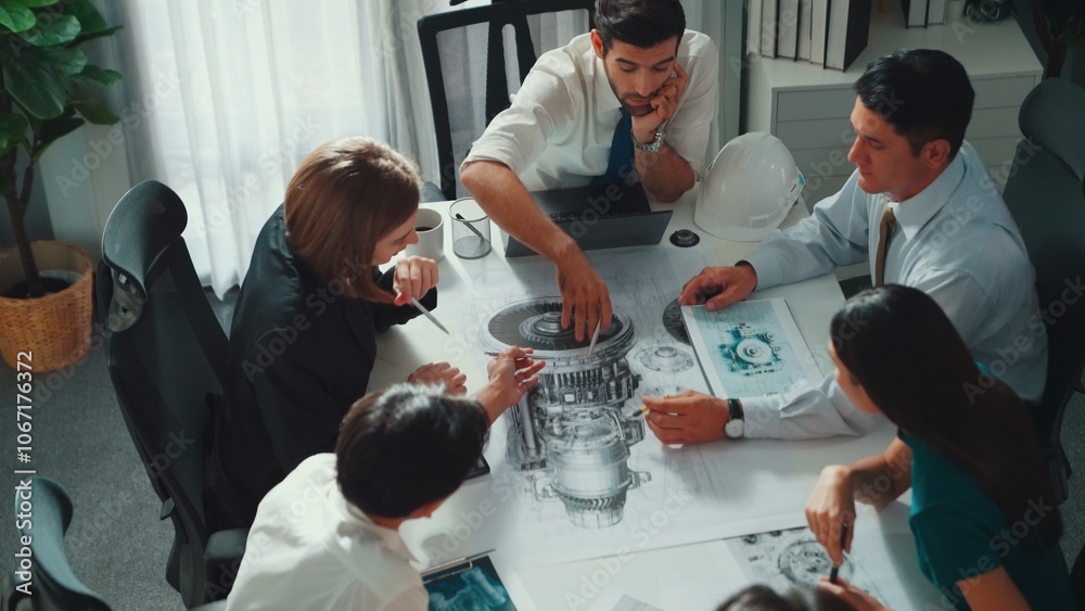 Naklejka premium Top view of professional engineer showing and talking about turbine engine design. Aerial view of skilled designer or technician group explain about electronic generator construction. Alimentation.