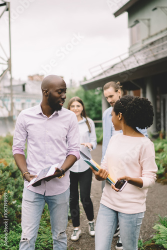 Modern diverse communicating and walking on building terrace