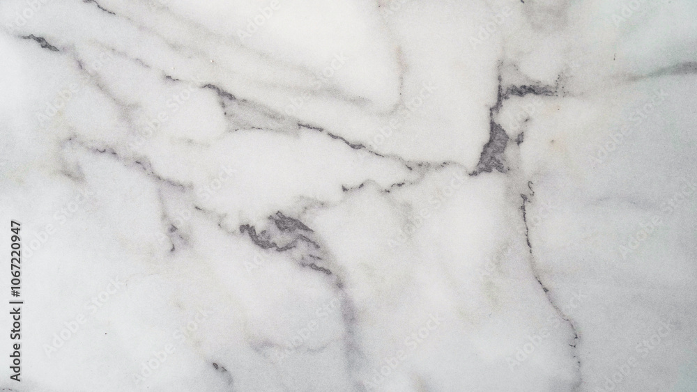 Fototapeta premium A close-up of a white marble surface with intricate gray veining. The natural patterns and textures create a luxurious and elegant aesthetic.