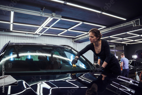 Technician polishing the car windshield