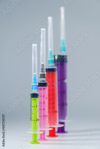 Medical disposable colored syringes. Injection equipment concept.