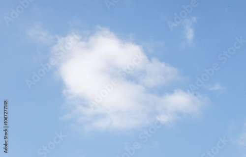 A cloudless blue sky with a single cloud in the middle