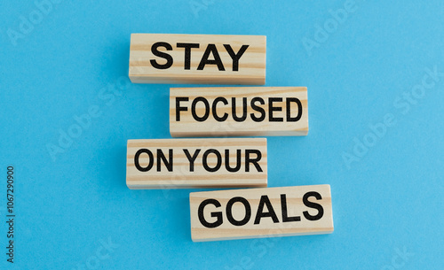 Wooden blocks with words Stay focused on your goals. photo