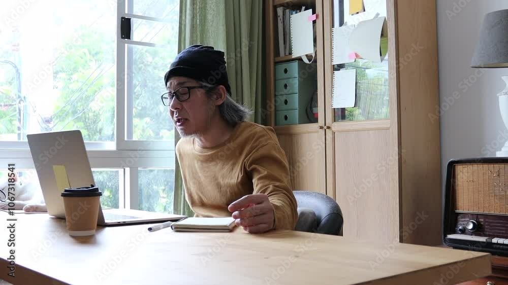 The Asian man working from home. The Asian man working from home.