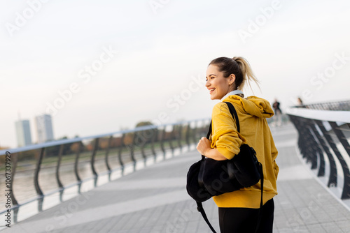 A joyful woman strolls alon...