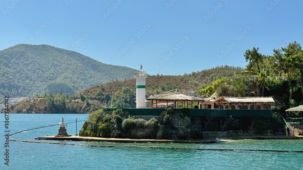 A white lighthouse standing at Fethiye Harbor in Turkey