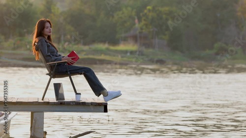 Wallpaper Mural Woman using laptop sitting on camp chairs on wooden pier bridge near lake, reading a book, enjoys drinking coffee and looking at beautiful landscape in the mountains. Beautiful current of river water. Torontodigital.ca