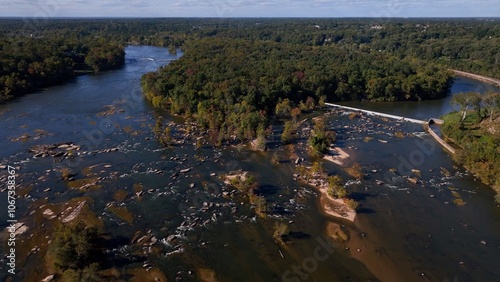 Natural river flowing around rocks and stones in afternoon sunshine Jame River Richmond, VA