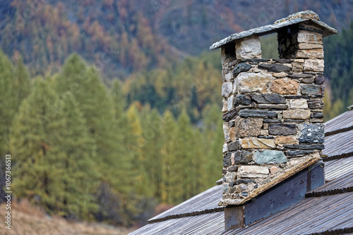 Chimney of traditional chalet in frenc akps under rain photo