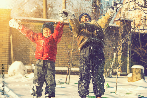 Two boys play with snow. Happy childhood. Brothers on a walk. two kids playing with snow. toned.