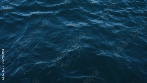 The ocean water flows slowly, creating a calm and serene atmosphere. View from above